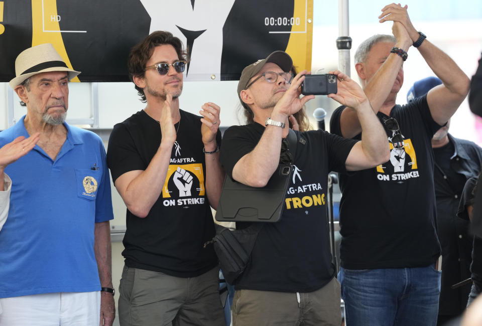 Actors F. Murray Abraham, from left, Matt Bomer, and Christian Slater attend the the SAG-AFTRA "Rock the City for a Fair Contract" rally in Times Square on Tuesday, July 25, 2023, in New York. The actors strike comes more than two months after screenwriters began striking in their bid to get better pay and working conditions. (Photo by Charles Sykes/Invision/AP)