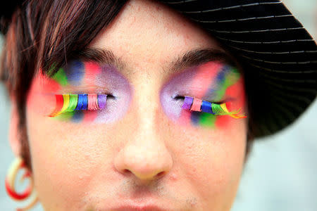 FILE PHOTO: A participant in Northern Ireland's Gay Pride parade poses for photographers at the start of the days festivities in Belfast August 1, 2009 REUTERS/Cathal McNaughton/File Photo