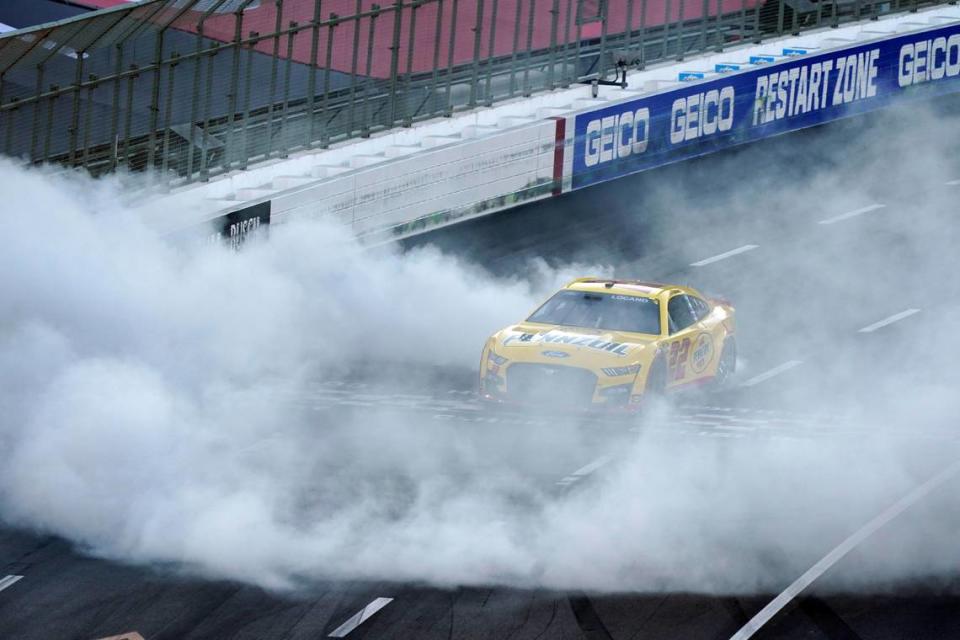 Joey Logano does a burnout at the start/finish line after winning a NASCAR exhibition auto race at Los Angeles Memorial Coliseum, Sunday, Feb. 6, 2022, in Los Angeles. (AP Photo/Marcio Jose Sanchez)