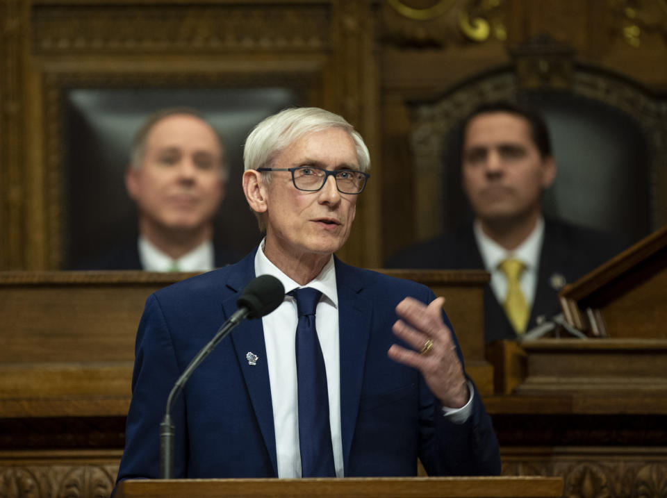 FILE - In this Jan. 22, 2019 file photo, Wisconsin Gov. Tony Evers addresses a joint session of the Legislature in the Assembly chambers during the Governor's State of the State speech at the state Capitol, in Madison, Wis. Behind Evers is Assembly Speaker Robin Vos, R-Rochester, left, and Senate President Roger Roth, R-Appleton. Evers tried for months for the Legislature to take up gun control bills to no avail. So he recently called a special session to force them to convene on the issue. (AP Photo/Andy Manis, File)