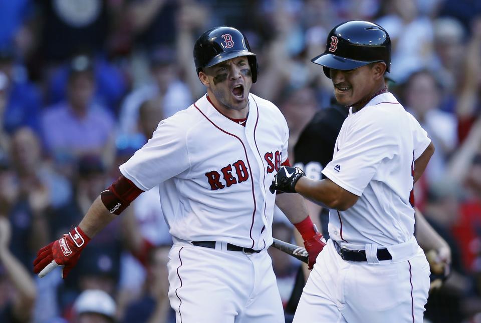 Boston Red Sox's Steve Pearce, left, reacts after Tzu-Wei Lin, right, scored the go-ahead run on a sacrifice fly by Andrew Benintendi during the eighth inning of a baseball game against the New York Mets in Boston, Sunday, Sept. 16, 2018. (AP Photo/Michael Dwyer)