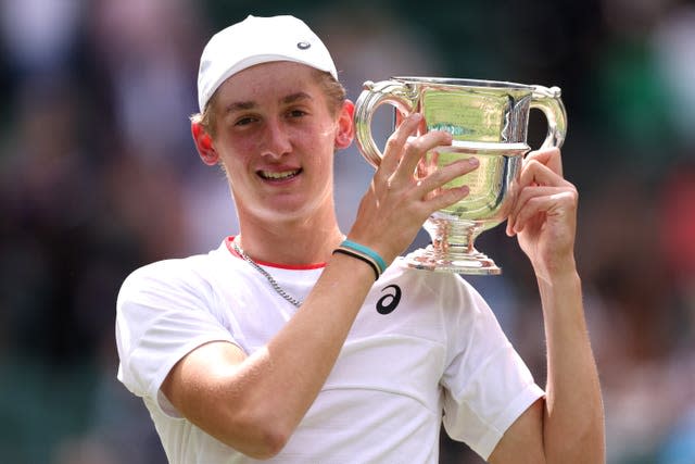 Henry Searle celebrates with the trophy after victory against Yaroslav in the boys’ singles final at Wimbledon