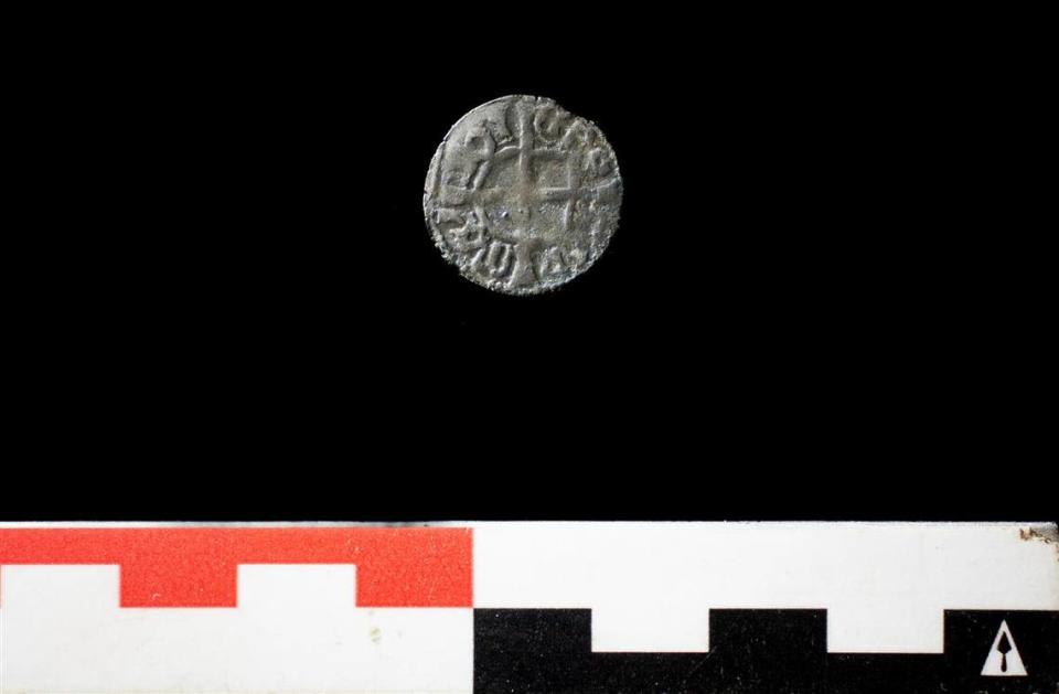 A close-up photo shows one of the 600-year-old coins.