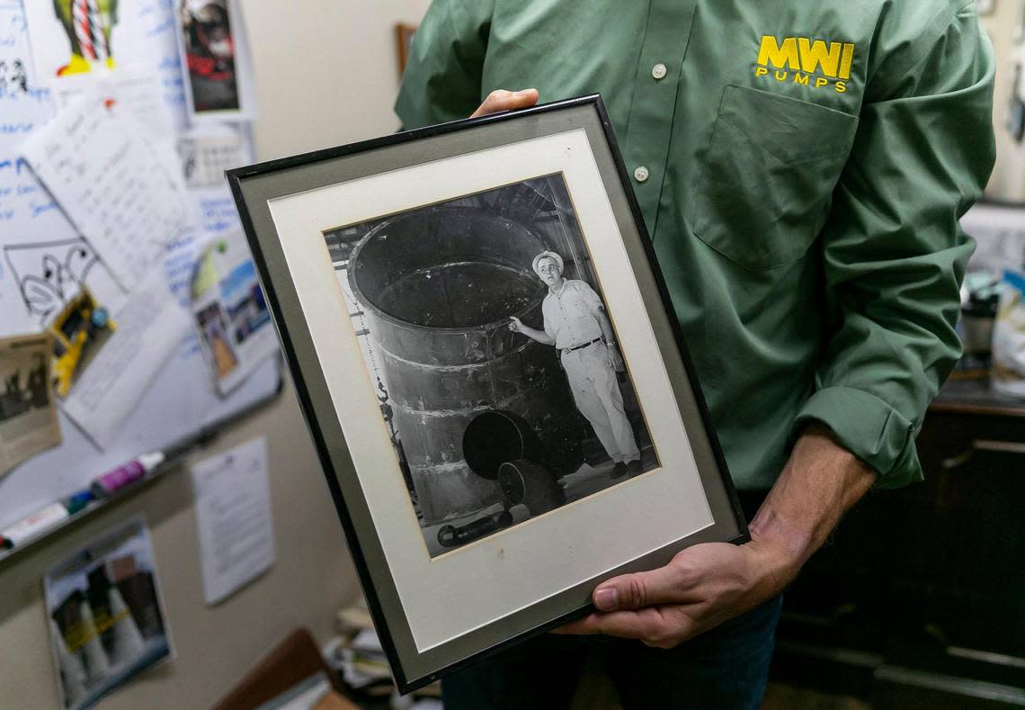 Dana Eller, the president of MWI Pumps, holds a photograph of his grandfather, Marlin Eller, during a tour of his corporate headquarters on Wednesday, Nov. 2, 2022, in Deerfield Beach, Fla.