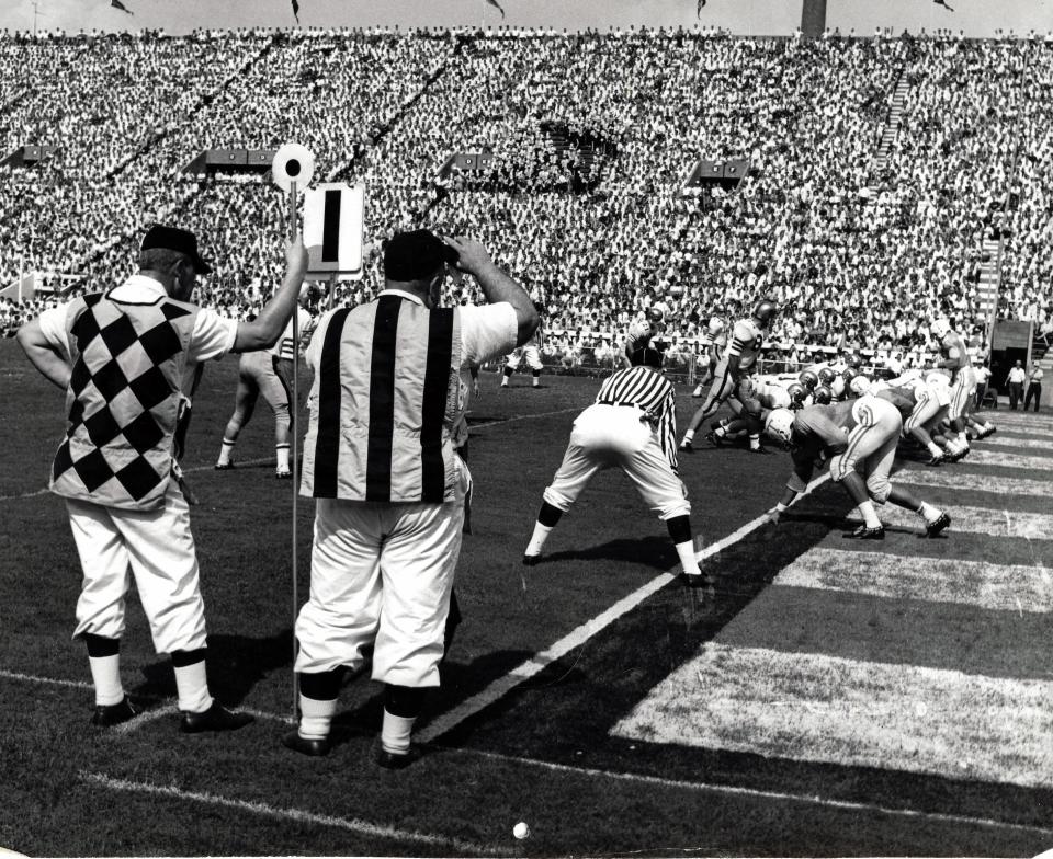 Sideline official "Big Sam" Venable (hand on the bill of his cap) holds the downs marker near the goal line during a Tennessee football game at Neyland Stadium, circa mid-1960s. Photo from Venable family collection.