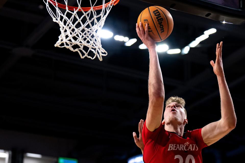 Cincinnati Bearcats forward Viktor Lakhin (30) hits a layup in the first half of the NCAA men’s basketball game between the Cincinnati Bearcats and the La Salle Explorers at Fifth Third Arena in Cincinnati on Saturday, Dec. 17, 2022. 