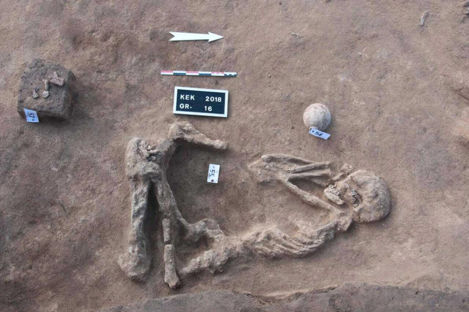 This undated handout photo provided by the Egyptian Antiquities Authority, shows a skeleton, at the Kom al-Kholgan archaeological site, about 140 kilometers (87 miles) north of Cairo, Egypt. The Antiquities Ministry said Wednesday, Jan. 23, 2019 that archaeologists have uncovered ancient tombs dating back to the Second Intermediate Period, 1782-1570 B.C., in the Nile Delta. (Egyptian Antiquities Authority via AP)