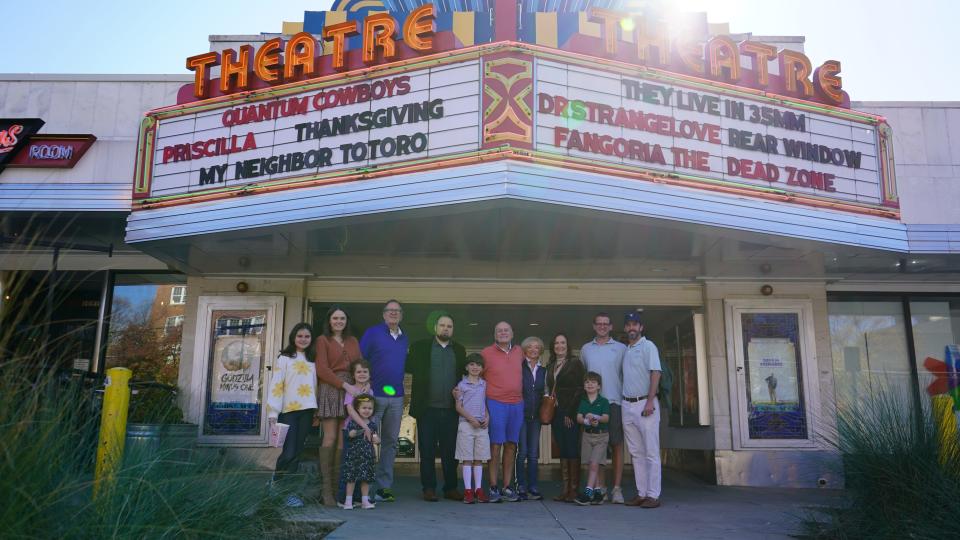 Christopher Escobar (center, black sports coat) with members of the Culbreth family and his own family in front of the Plaza Theatre. The Culbreth family visited the theatre in November 2023 after workers found a wallet their late matriarch lost there 65 years ago.