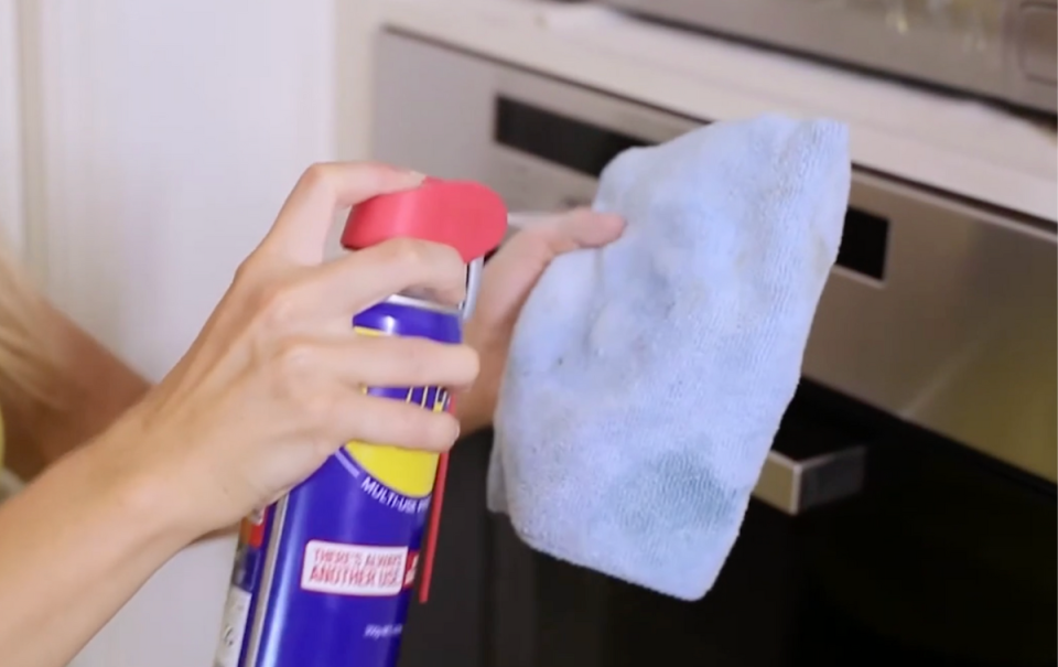 WD40 being sprayed on a cloth