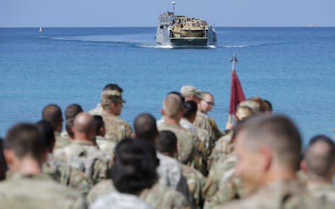 Soldiers from the 602nd Area Support Medical Company wait on a beach for a Navy landing craft as their unit evacuates in advance of Hurricane Maria - Credit: JONATHAN DRAKE/Reuters