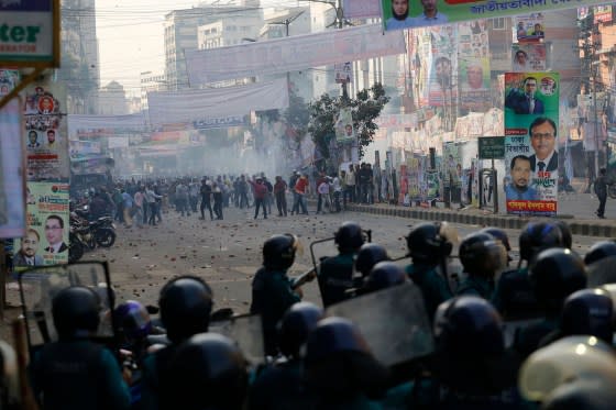 Police stand guard as Bangladesh Nationalist Party activists gather in Dhaka ahead of a rally to demand Hasina’s resignation in December 2022.<span class="copyright">Rehman Asad—AFP/Getty Images</span>