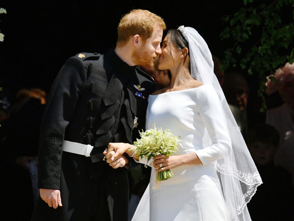 Prince Harry and Meghan Markle share a kiss at the royal wedding in 2018.