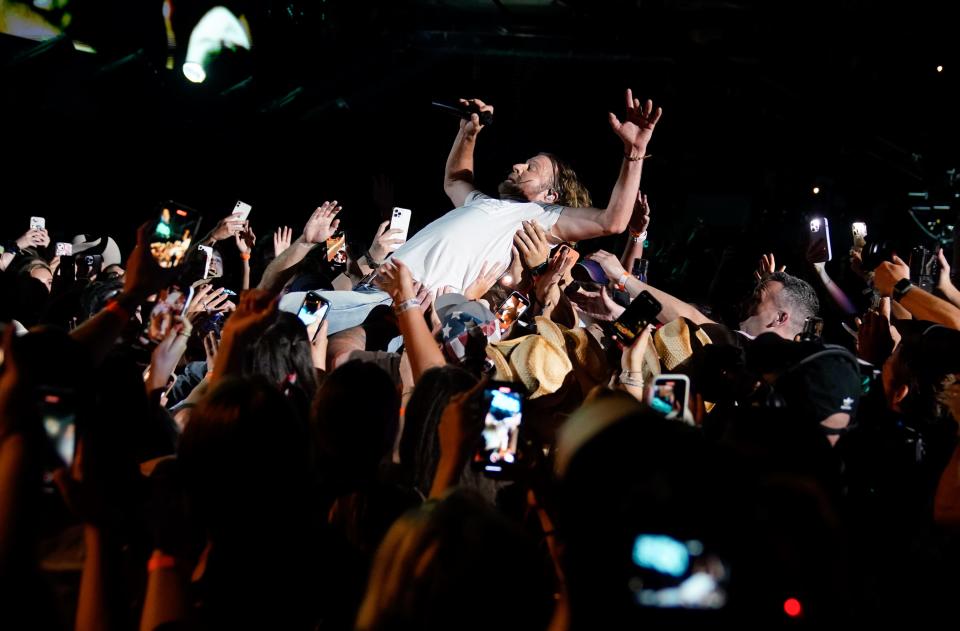 Dierks Bentley jumps into the crowd during CMA Fest at Nissan Stadium on Sunday, June 11, 2023, in Nashville, Tennessee.