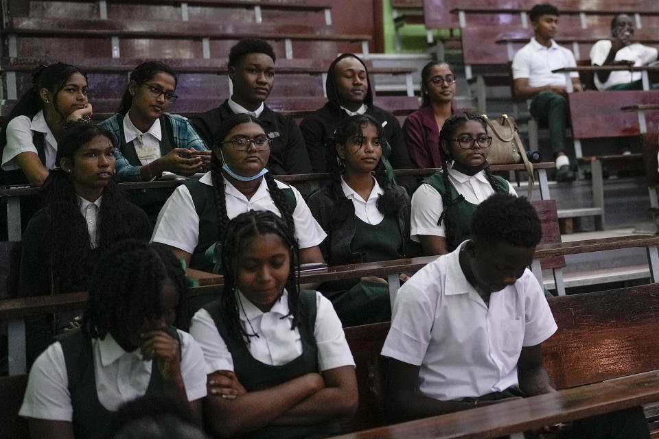 High school students attend ExxonMobil's presentation at a job fair at the University of Guyana in Georgetown, Guyana, Friday, April 21, 2023. Excitement and curiosity were in the air as students met with oil companies, support and services firms, and agricultural groups. (AP Photo/Matias Delacroix)