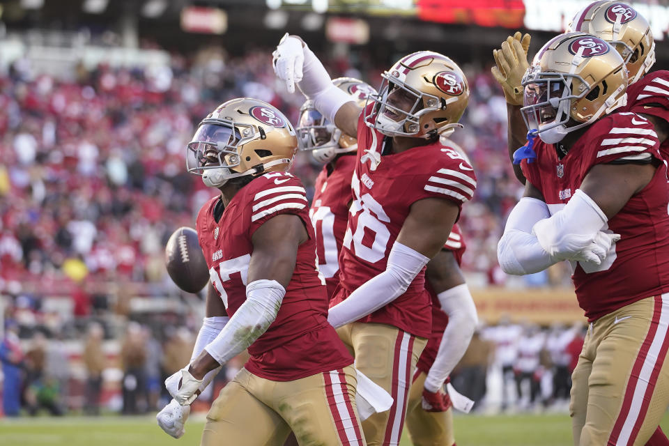 San Francisco 49ers safety Ji'Ayir Brown, left, celebrates with teammates after intercepting a pass from Tampa Bay Buccaneers quarterback Baker Mayfield during the second half of an NFL football game in Santa Clara, Calif., Sunday, Nov. 19, 2023. (AP Photo/Godofredo A. Vásquez)
