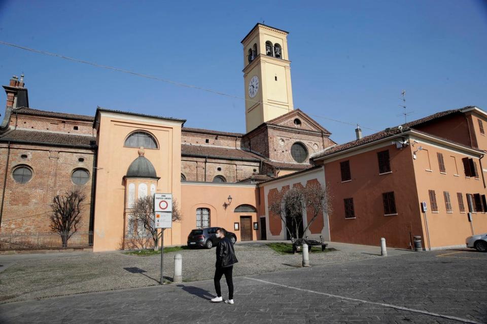 A man walks past the San Biagio church in Codogno in northern Italy on Saturday.