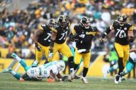 Jan 8, 2017; Pittsburgh, PA, USA; Pittsburgh Steelers quarterback Ben Roethlisberger (7) carries the ball in the third quarter against the Miami Dolphins in the AFC Wild Card playoff football game at Heinz Field. Mandatory Credit: James Lang-USA TODAY Sports