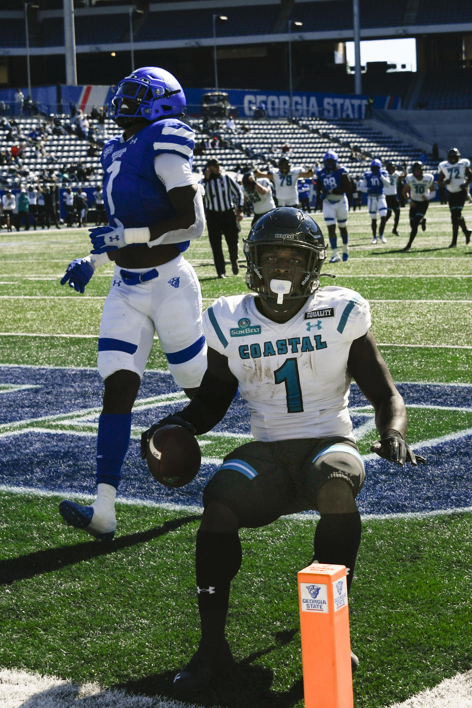 Coastal Carolina running back CJ Marable scores a touchdown on a reception in front of Georgia State linebacker Jordan Strachan (7) during the first half of an NCAA football game Saturday, Oct. 31, 2020, in Atlanta. (AP Photo/John Amis)