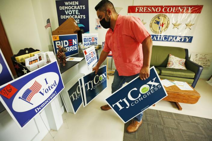 Humberto Gomez, regional director of the California Democratic Party, collects T.J. Cox signs at the Fresno headquarters.