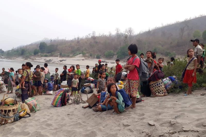 Karen refugees carrying belongings are seen at Salween riverbank in Mae Hong Son