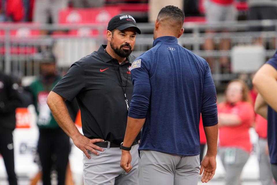 Sep 3, 2022; Columbus, Ohio, USA;  Ohio State Buckeyes head coach Ryan Day talks to Notre Dame Fighting Irish head coach Marcus Freeman prior to the NCAA football game at Ohio Stadium. Mandatory Credit: Adam Cairns-USA TODAY Sports