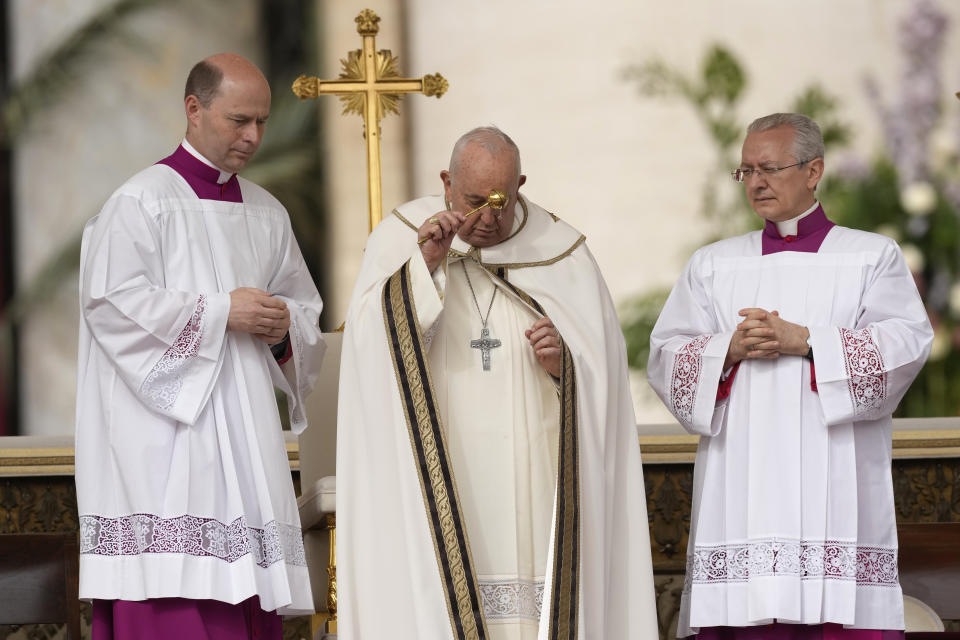 Pope Francis asperses holy water as he celebrates Easter mass in St. Peter's Square at the Vatican, Sunday, March 31, 2024. (AP Photo/Andrew Medichini)