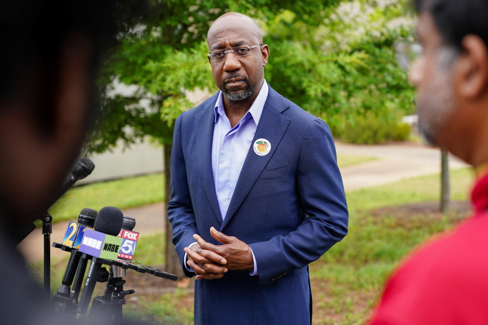 U.S. Senator Raphael Warnock is seen at a press conference after casting his ballot in the state's general primary at a Fulton County polling station in Atlanta, Georgia, U.S. May 6, 2022.  REUTERS/Elijah Nouvelage