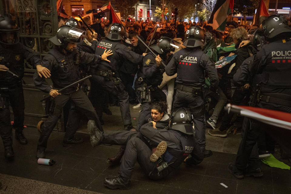 Police officers clash with pro-Palestinian demonstrators as they try to enter at a train station in Barcelona, Spain, Saturday, Nov. 11, 2023. (AP Photo/Emilio Morenatti)