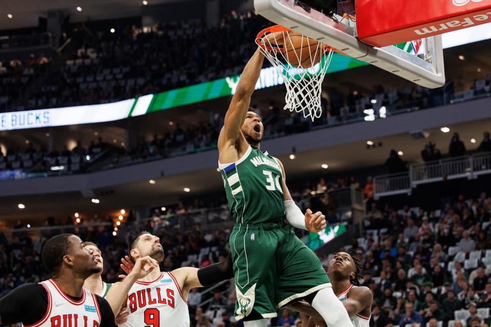 Giannis Antetokounmpo slams home two of his game-high 33 points.