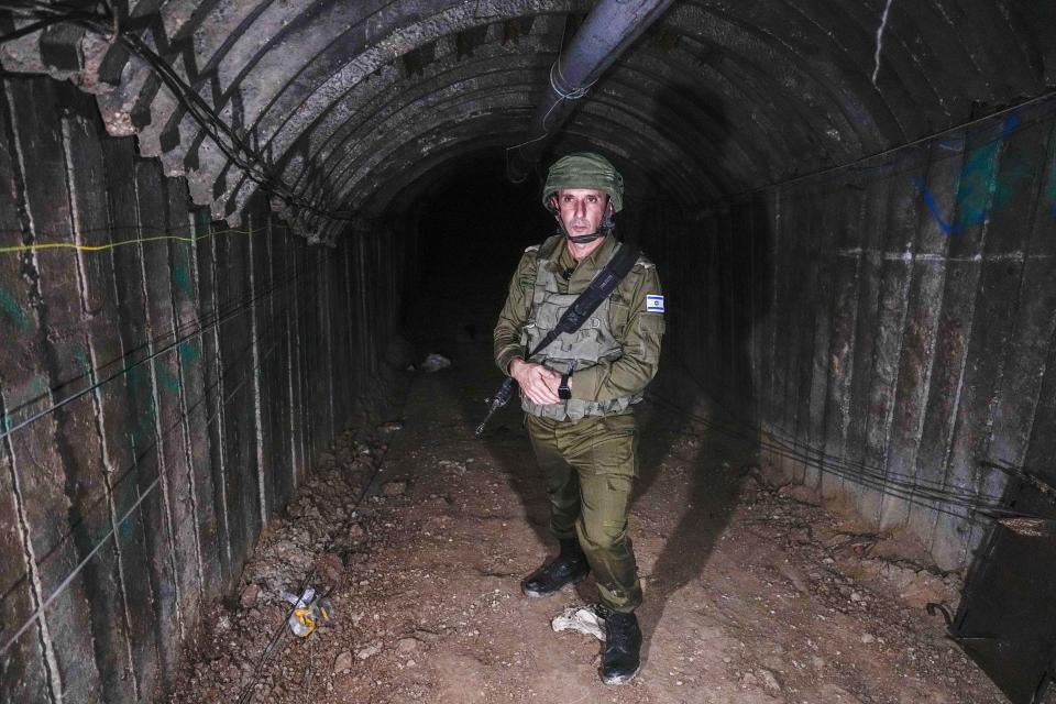 Israeli military spokesperson, Rear Adm. Daniel Hagari, speaks to the media in a tunnel that the military says Hamas militants used to attack the Erez crossing in the northern Gaza Strip, Friday, Dec. 15, 2023. The army is battling Palestinian militants across Gaza to retaliate for Hamas' Oct. 7 attack on Israel. (AP Photo/Ariel Schalit)