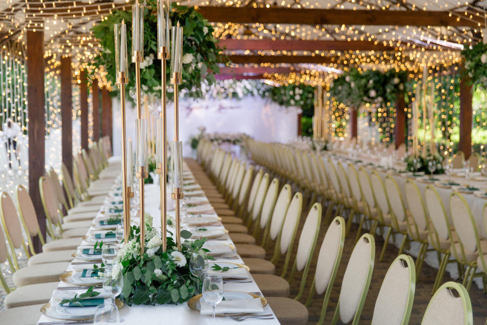 Rows of seating accented with flowers on the tables and tea lights overhead
