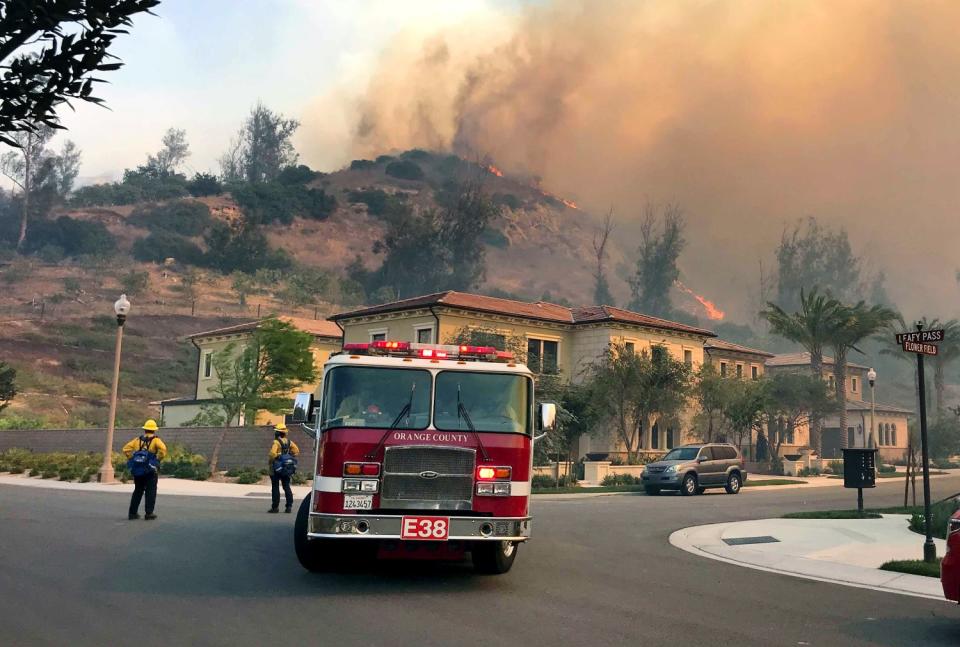 Firefighters do structure protection for homes in Irvine as the Silverado fire continues to burn.