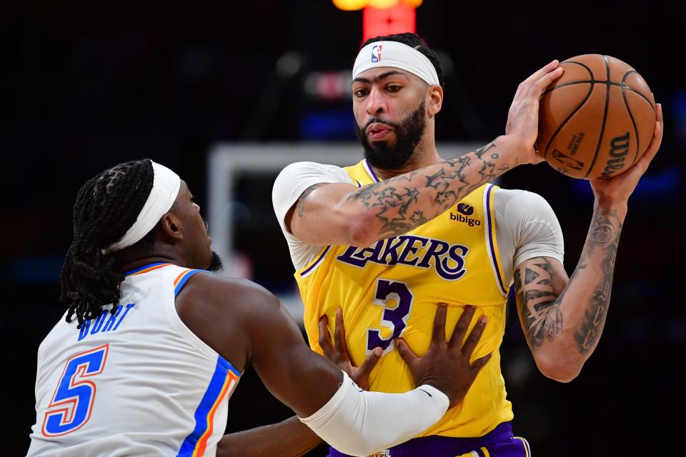 Los Angeles Lakers forward Anthony Davis (3) controls the ball against Oklahoma City Thunder guard Luguentz Dort (5) during the first half at Crypto.com Arena.