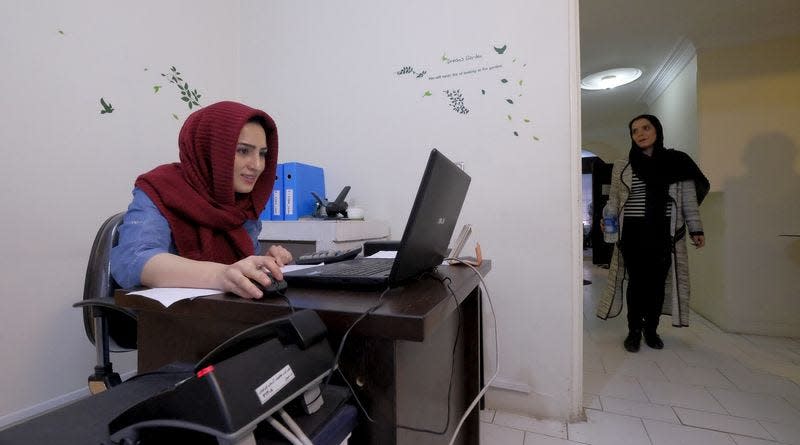 An employee works with her laptop at Takhfifan company in Tehran, Iran, January 19, 2016. REUTERS/Raheb Homavandi/TIMA