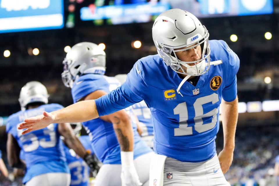 Detroit Lions quarterback Jared Goff high-fives teammates during warmups before the game against the Green Bay Packers at Ford Field in Detroit on Thursday, Nov. 23, 2023.