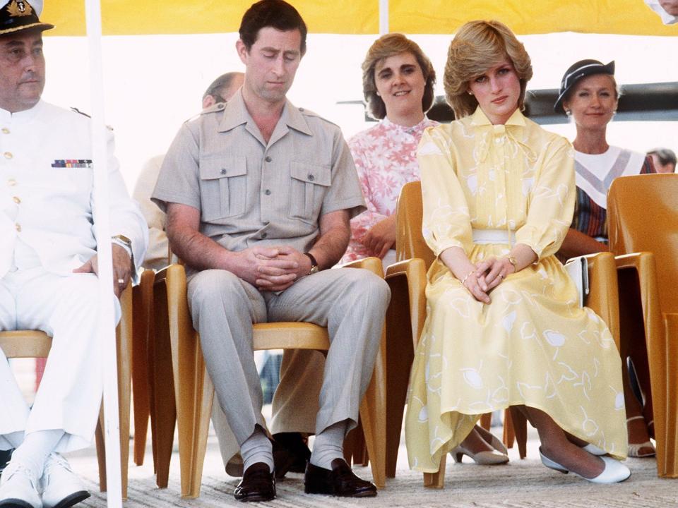 King Charles and Princess Diana sit in chairs.