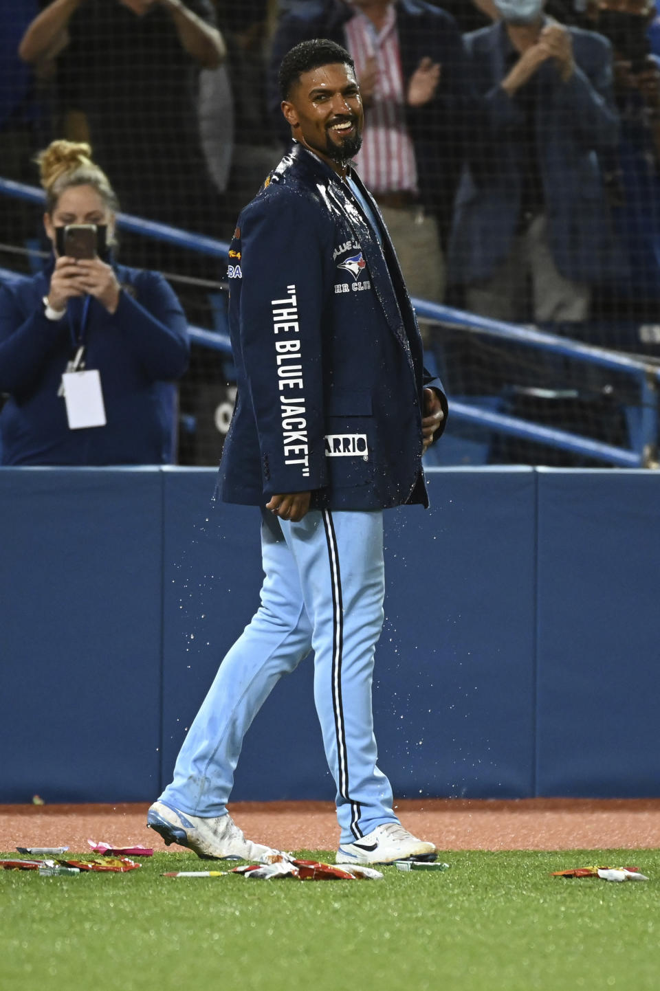 Toronto Blue Jays' Marcus Semien, smiles after getting doused by teammates after hitting a three-run walkoff home run in the ninth inning of a baseball game against the Oakland Athletics in Toronto, Friday, Sept. 3, 2021. (Jon Blacker/The Canadian Press via AP)