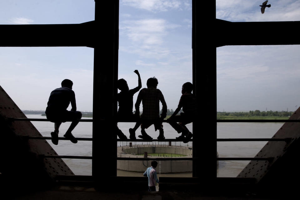 Indian children sit on the side bars