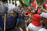 <p>A protester tries to block police from advancing to others after they briefly scuffle with police during a rally near the U.S. Embassy in Manila to protest this weekend’s visit of President Donald Trump on Saturday, Nov. 11, 2017 in Manila, Philippines. (Photo: Aaron Favila/AP) </p>