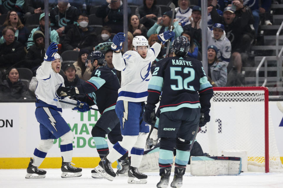 Tampa Bay Lightning center Anthony Cirelli (71) and center Alex Barre-Boulet, left, react after Cirelli scored against the Seattle Kraken during the first period of an NHL hockey game Saturday, Dec. 9, 2023, in Seattle. (AP Photo/Jason Redmond)