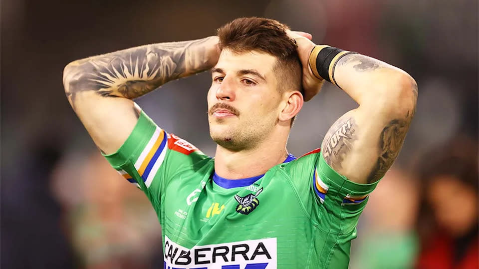 Pictured here, Curtis Scott has his hands on his head during a game for the Canberra Raiders. 