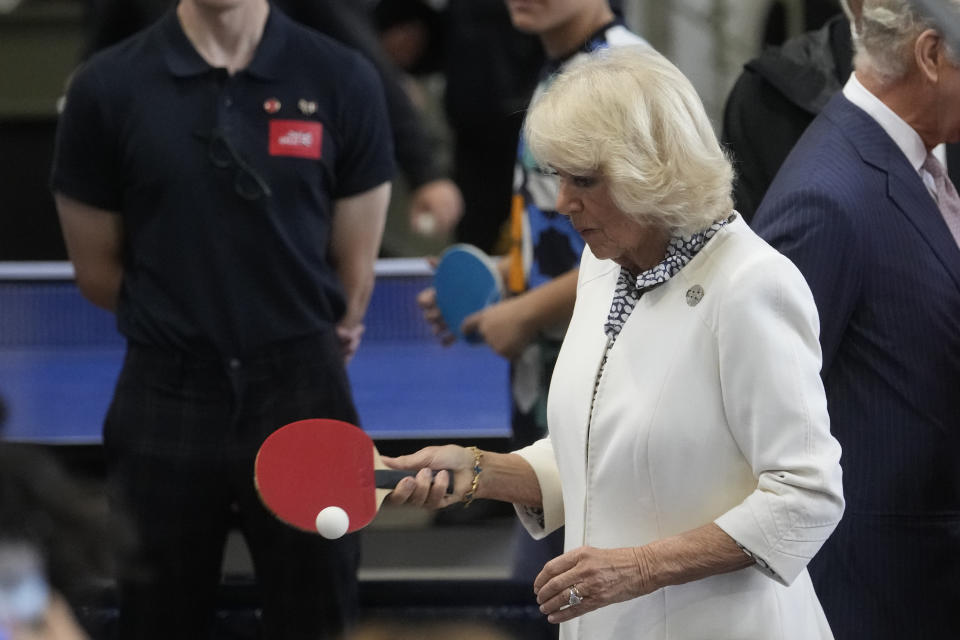 Britain's Queen Camilla plays table tennis during a visit to a gymnasium, Thursday, Sept. 21, 2023 in Saint-Denis, outside Paris. (AP Photo/Thibault Camus)