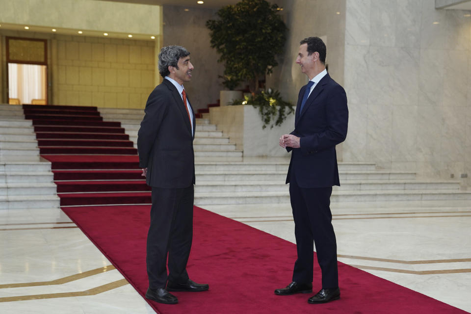 In this photo released by the Syrian official news agency SANA, shows Syrian President Bashar Assad, right, speaks with Sheikh Abdullah bin Zayed Al Nahyan, the Foreign Minister of the United Arab Emirates, in Damascus, Syria, Tuesday, Nov. 9, 2021. Al Nahyan's visit to Syria is the first time since the Syrian conflict began a decade ago and comes as some Arab countries are improving relations with Syria. The UAE has been slowly mending ties with Damascus, as the tide of the war has turned in favor of President Bashar Assad. (SANA via AP)