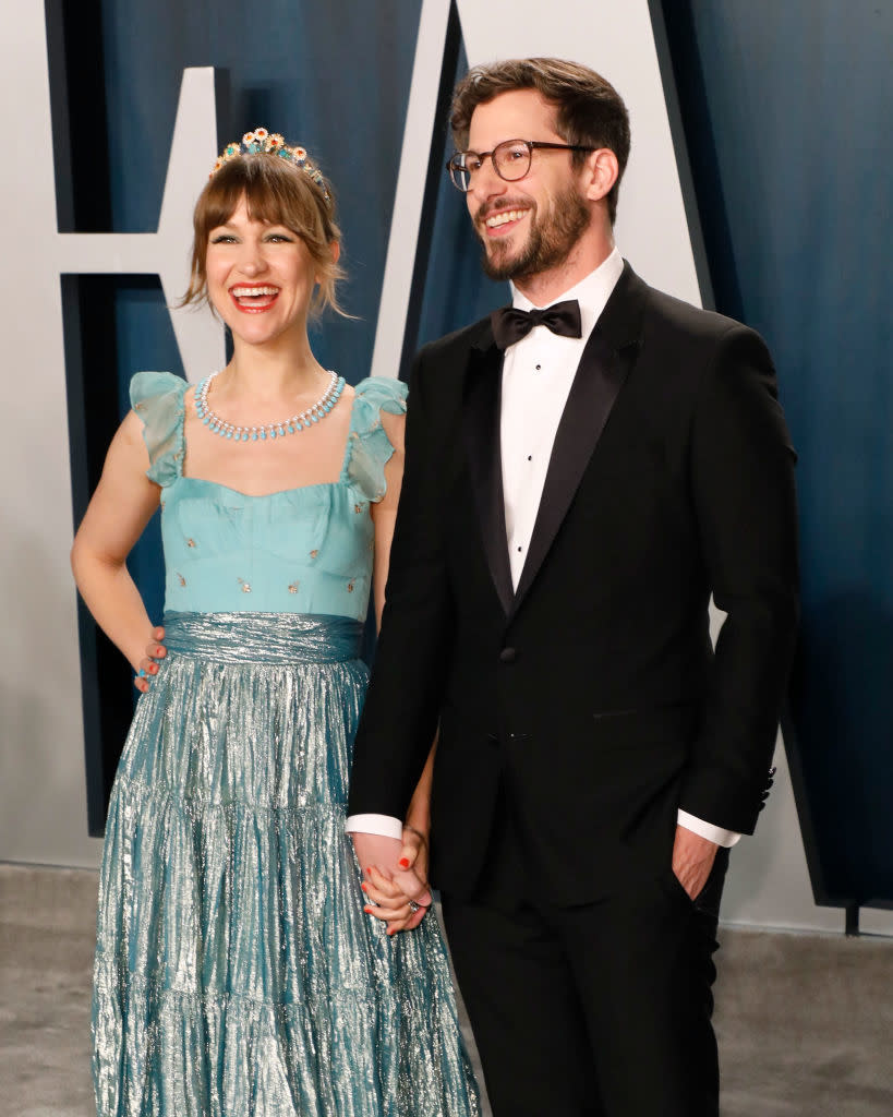 closeup of the two holding hands and smiling at an event