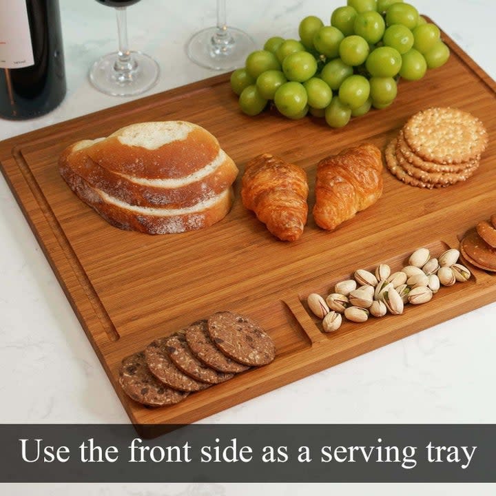 slices of bread, crackers, nuts and fruit spread across the chopping board like a charcuterie display