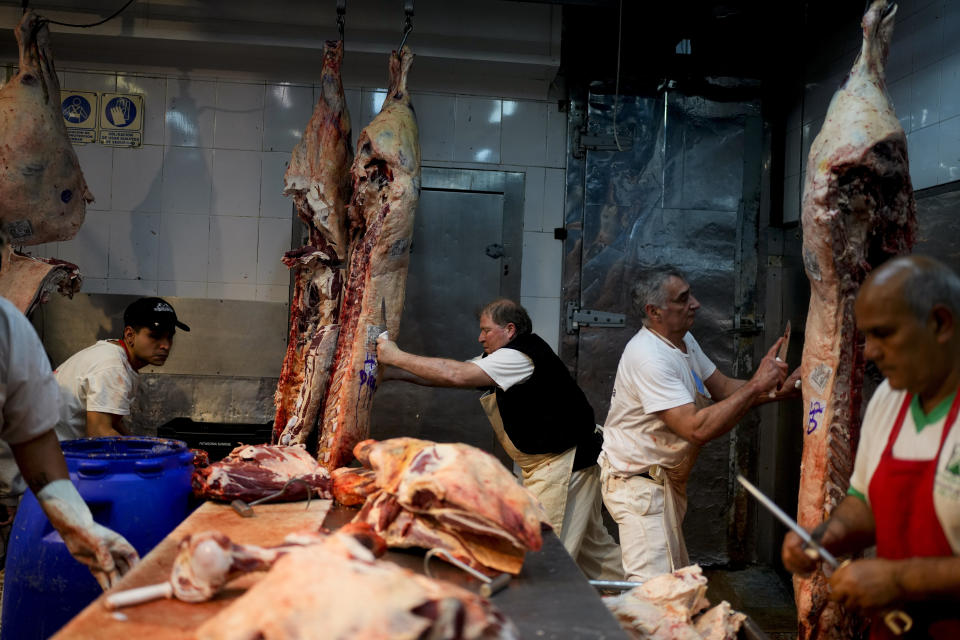 Butchers cut meat for sale at a shop in Buenos Aires, Argentina, early Wednesday, Sept. 13, 2023. Argentina has one of the world’s highest inflation rates. (AP Photo/Natacha Pisarenko)