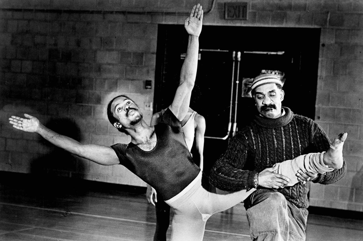 Garth Fagan gives some help to one of his dancers, Steven Humphrey, on the proper form for a routine during their practice of the Bucket Dancers.