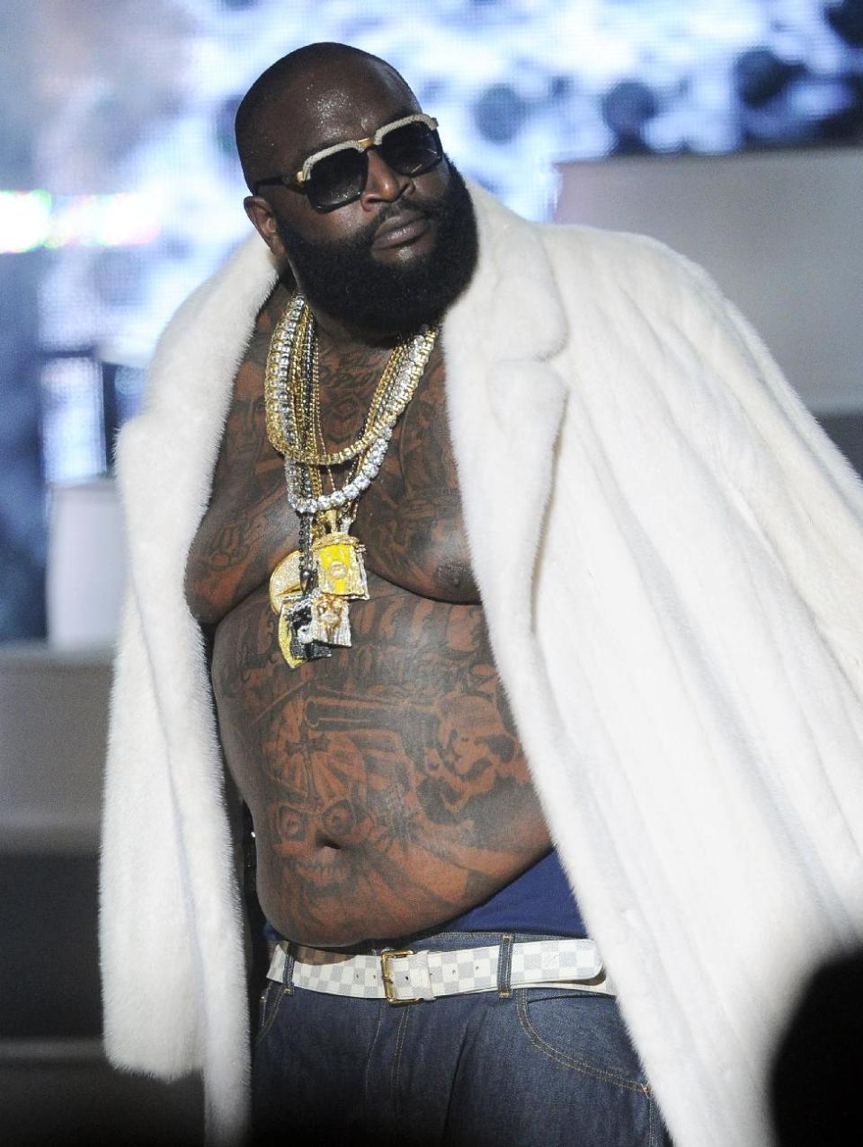 FILE - This Sept. 29, 2012 file photo shows Rick Ross performing at the BET Hip-Hop Honors at Boisfeuillet Jones Atlanta Civic Center in Atlanta. Police in South Florida say rapper Rick Ross crashed his Rolls Royce into a building after hearing shots fired nearby. Police say Ross and a female companion reported hearing multiple shots fired in their direction early on Monday, Jan. 28, 2013. Police say Ross lost control of the silver Rolls and crashed into an apartment building. Neither Ross nor his passenger was injured and police say it did not appear that any bullets struck the Rolls. (Photo by John Amis/Invision/AP, file)