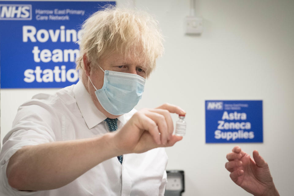 LONDON, ENGLAND - JANUARY 25: British Prime Minister Boris Johnson holds a vial of the Oxford/Astrazeneca coronavirus vaccine during a visit to Barnet FC's ground at The Hive on January 25, 2021 in London, England. Government figures show that 6.3 million people across the UK have received their first dose of the coronavirus vaccine, as 32 more vaccination centres open across England. (Photo by Stefan Rousseau - WPA Pool/Getty Images)