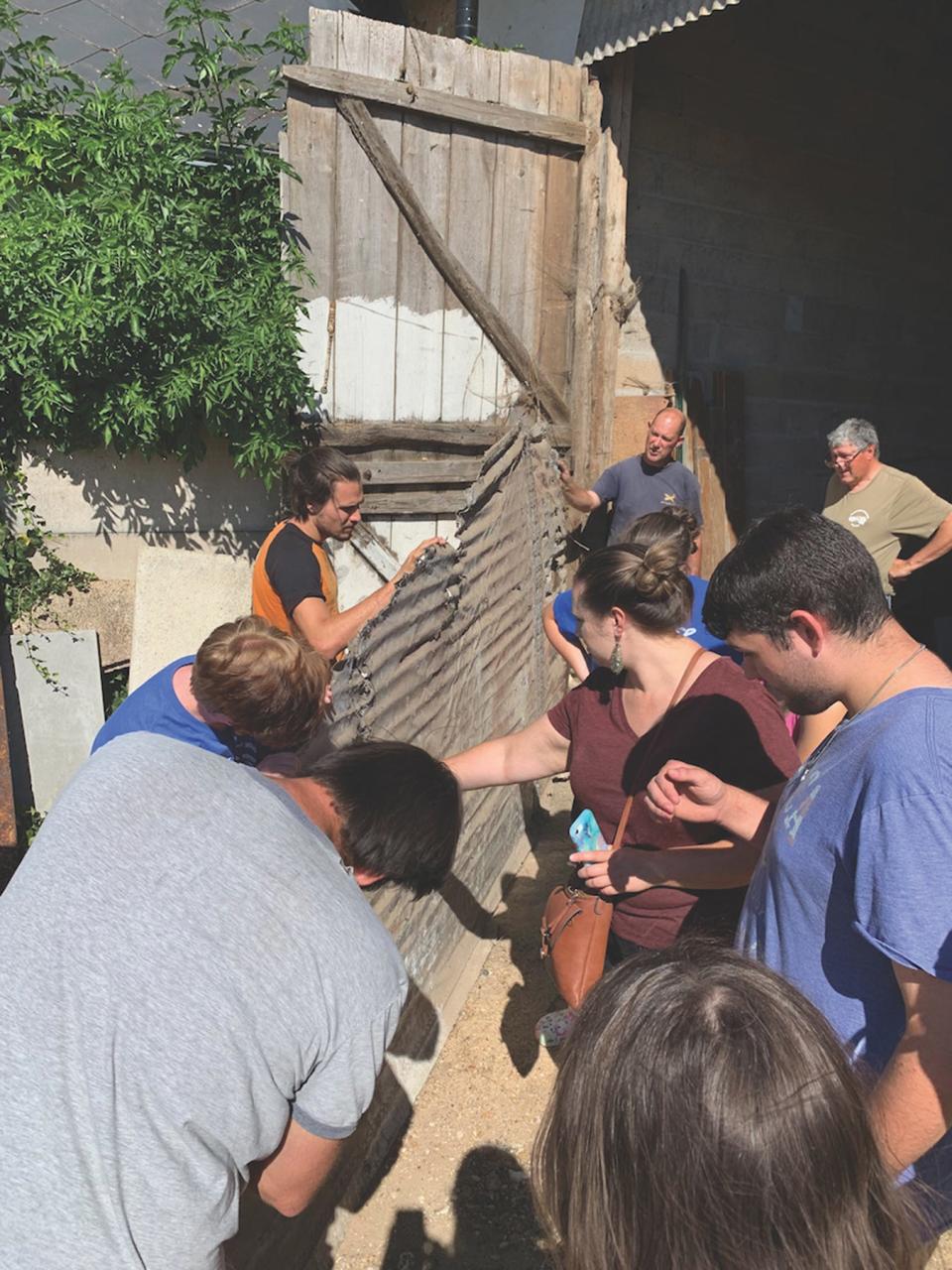 In this 2022 file photo, a group of MTSU students examine a World War II aircraft wing in France as part of a university study abroad group working to help repatriate the remains of tens of thousands of American service personnel who are unaccounted for from past conflicts, many from World War II.